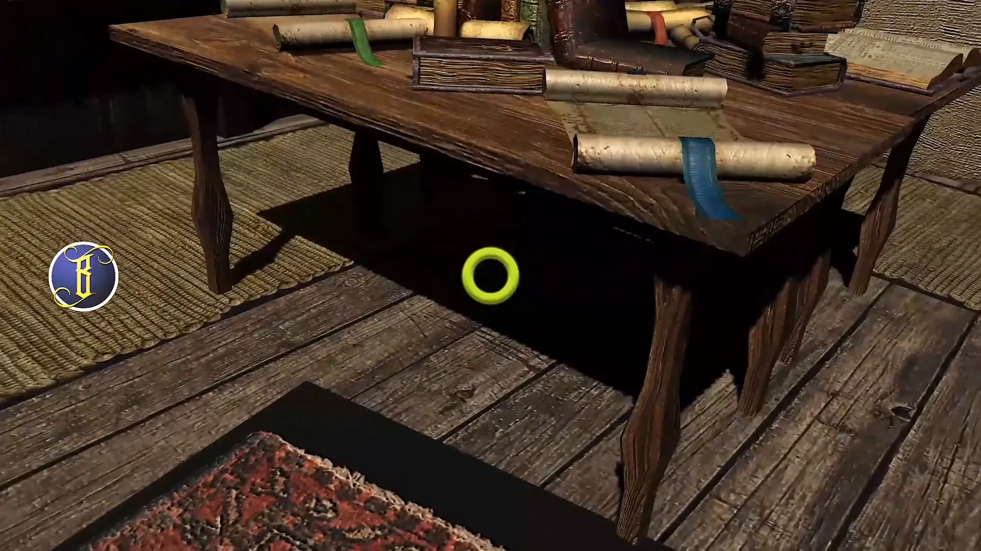 A wooden library table covered in scrolls and books on a plank floor with a patterned rug.